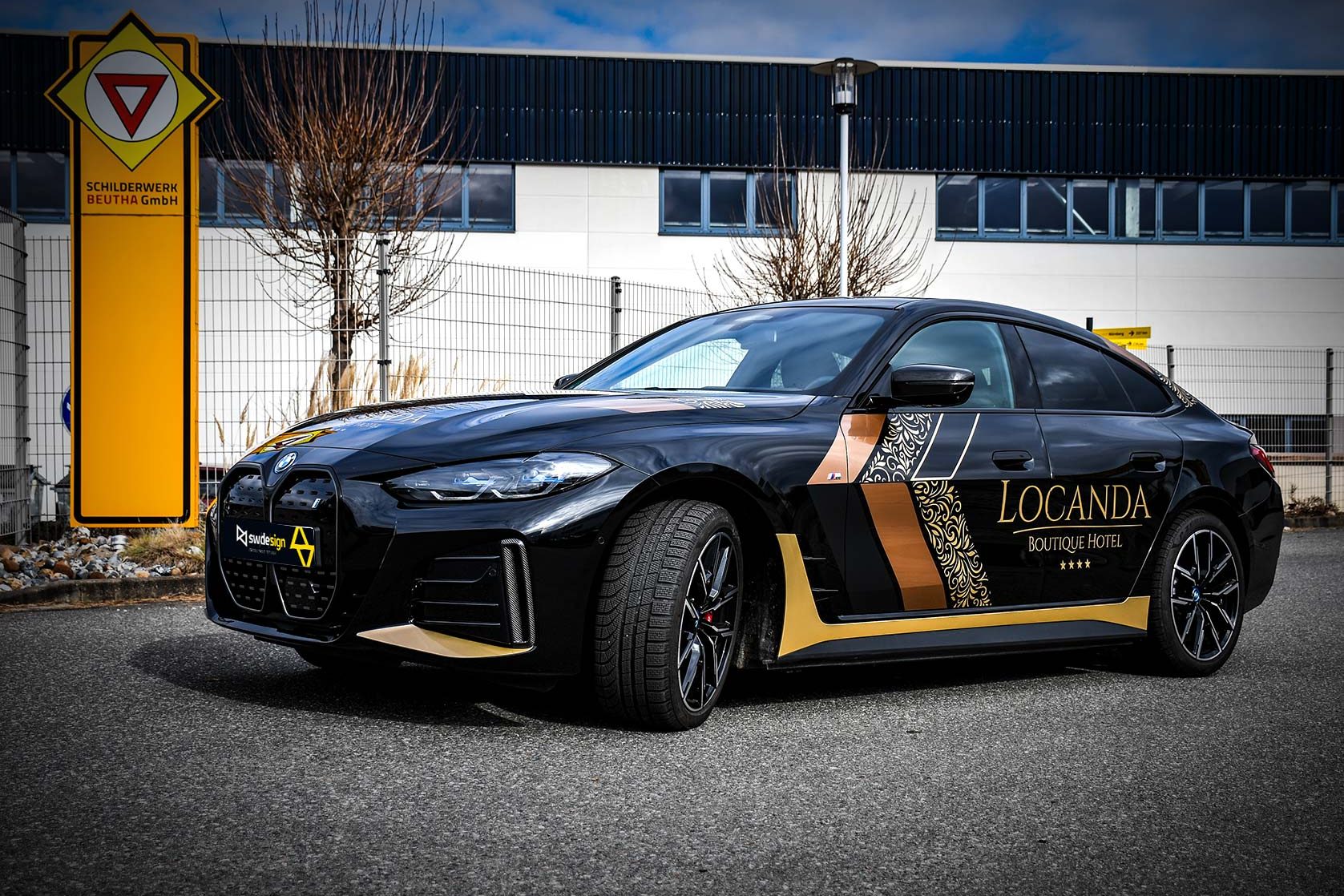 Schwarzer BMW mit hochwertiger Folierung im Design des Locanda Boutique Hotels.